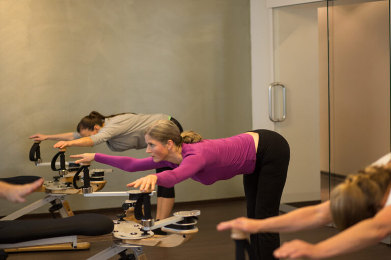 Participants in a group class using various Gyrotonic machines.