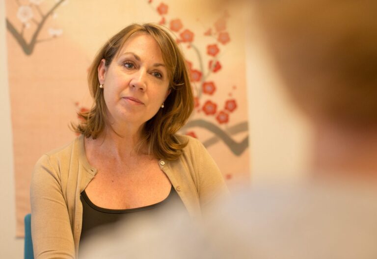 Therapist talking to patient
